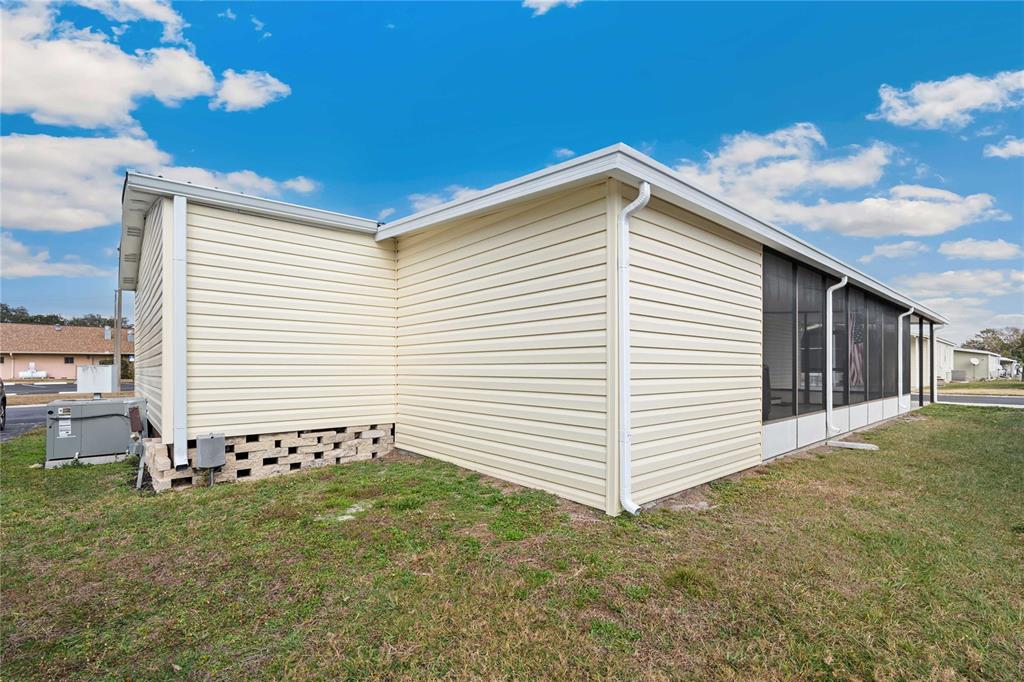 3125 Briar Street Wesley Chapel, FL 33543 - Photo 29 of 42 a view of a white house with a yard