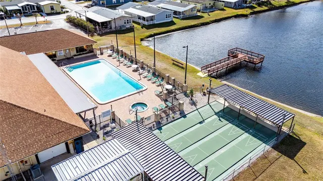 an outdoor space with swimming pool and seating