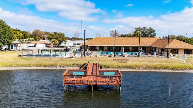 an aerial view of a house with a swimming pool outdoor seating and yard