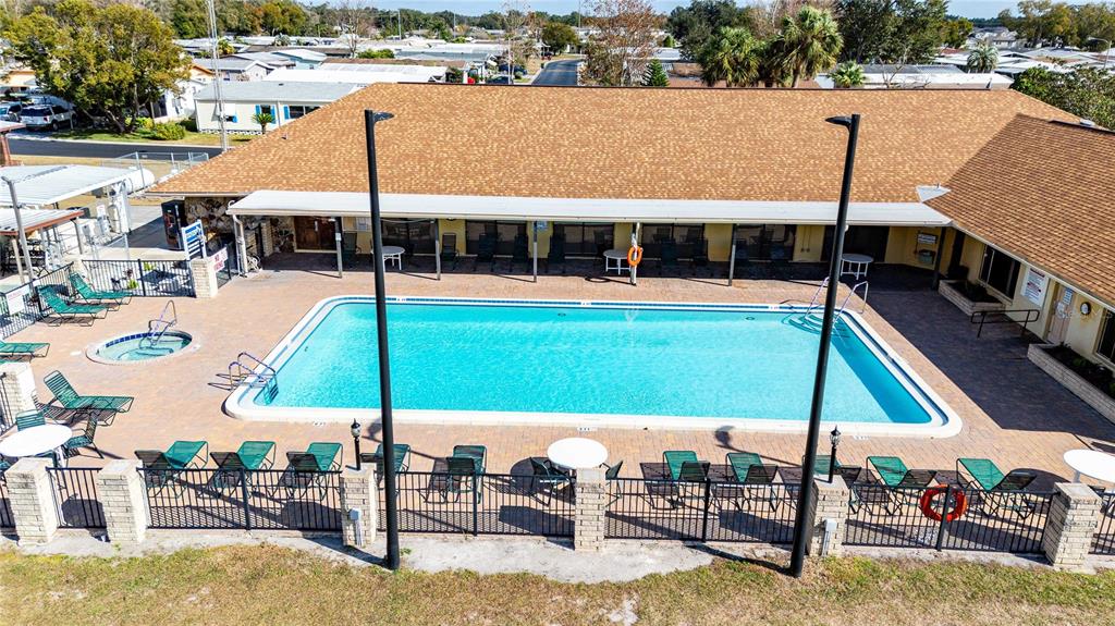 3125 Briar Street Wesley Chapel, FL 33543 - Photo 38 of 42 a view of a swimming pool with lawn chairs under an umbrella