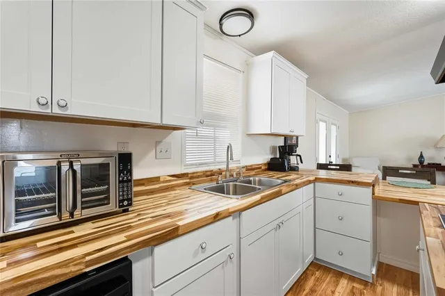 a kitchen with sink cabinets and stainless steel appliances