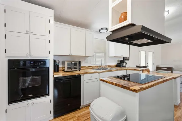 a kitchen with stainless steel appliances granite countertop a sink and a stove