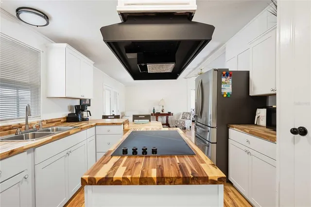 a kitchen with a sink appliances and cabinets