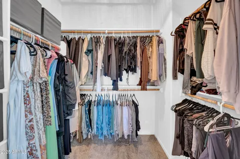 a spacious bedroom with a bed and a window