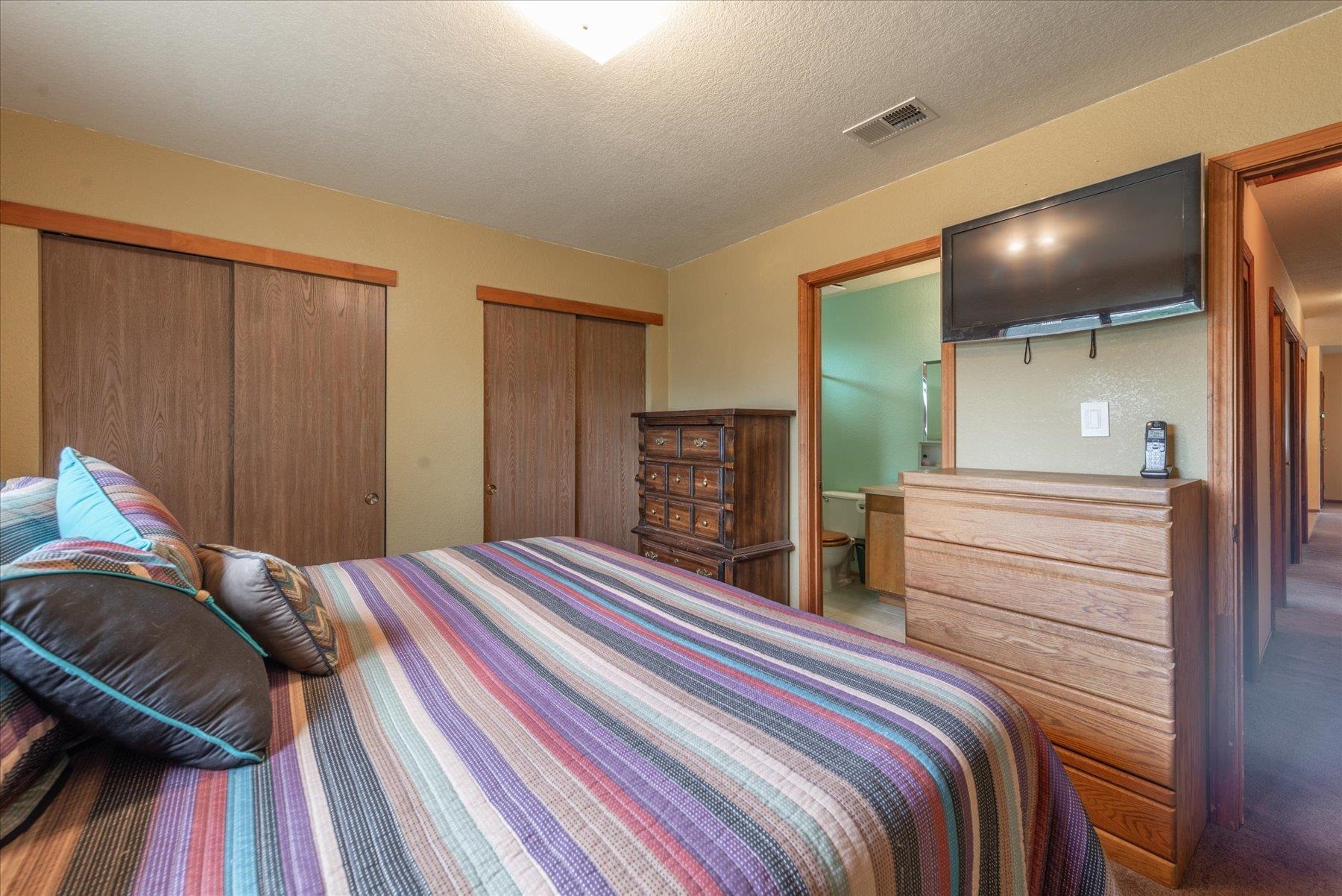 16006 Rolands Way Truckee, CA 96161 - Photo 15 of 19 a bedroom with a bed and a walk in closet