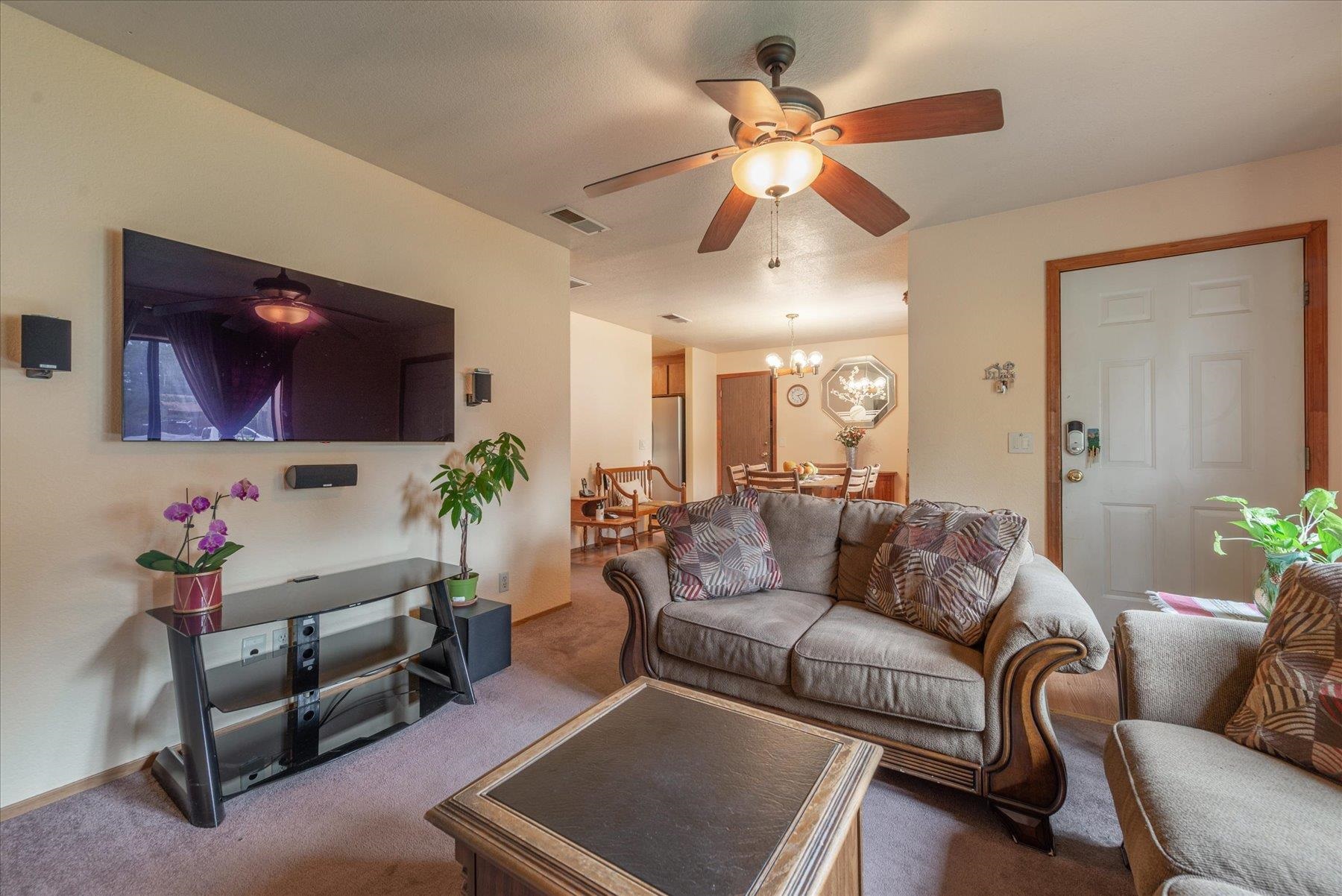 16006 Rolands Way Truckee, CA 96161 - Photo 5 of 19 a living room with furniture kitchen view and a flat screen tv