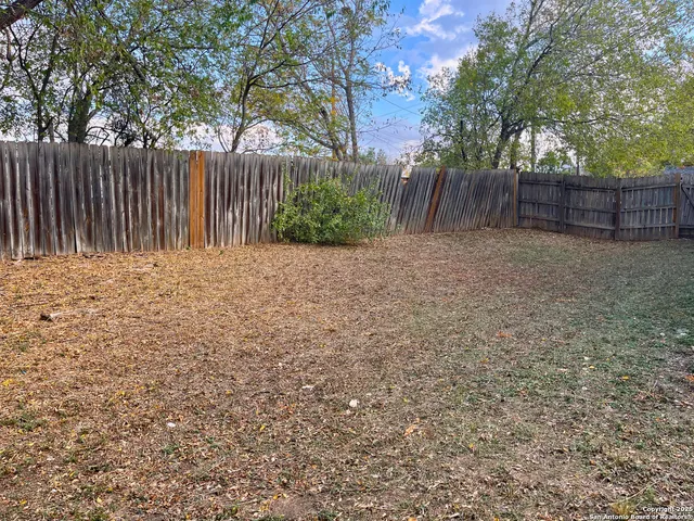 a wooden fence with trees in the background