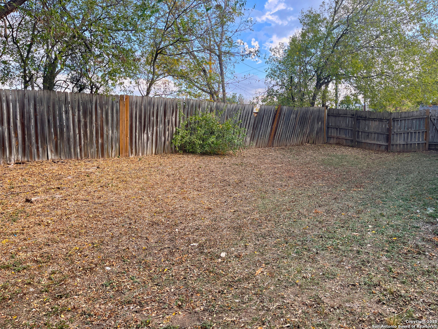 7727 Broken Arrow Converse, TX 78109 - Photo 16 of 17 a wooden fence with trees in the background