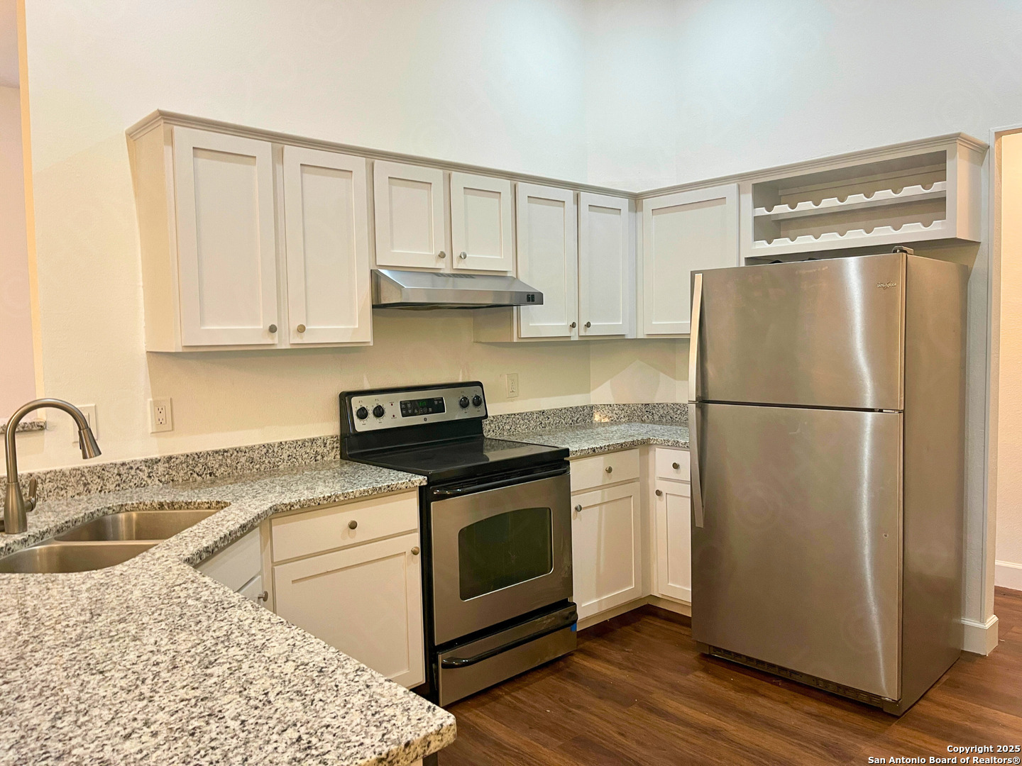7727 Broken Arrow Converse, TX 78109 - Photo 7 of 17 a kitchen with a refrigerator sink and cabinets