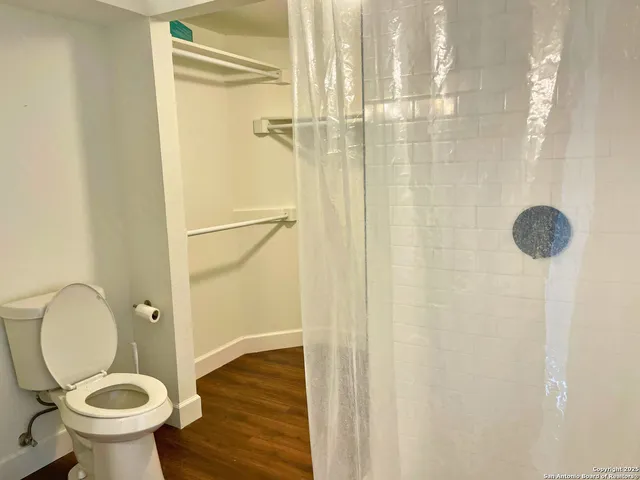 a bathroom with a toilet and a shower