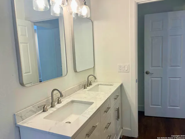 a bathroom with a double vanity sink and mirror