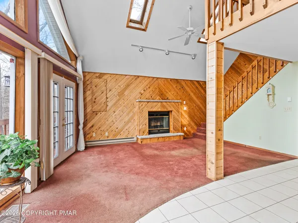 a view of kitchen with refrigerator and window