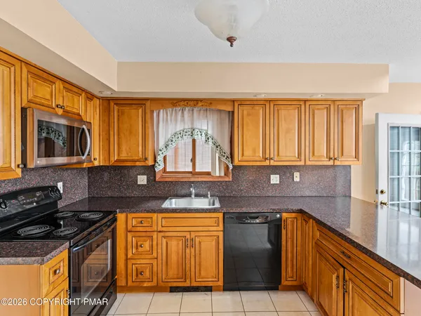 a view of an empty room with a fireplace and a large window