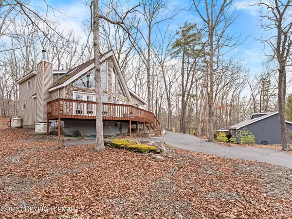a view of house with outdoor space and covered with trees