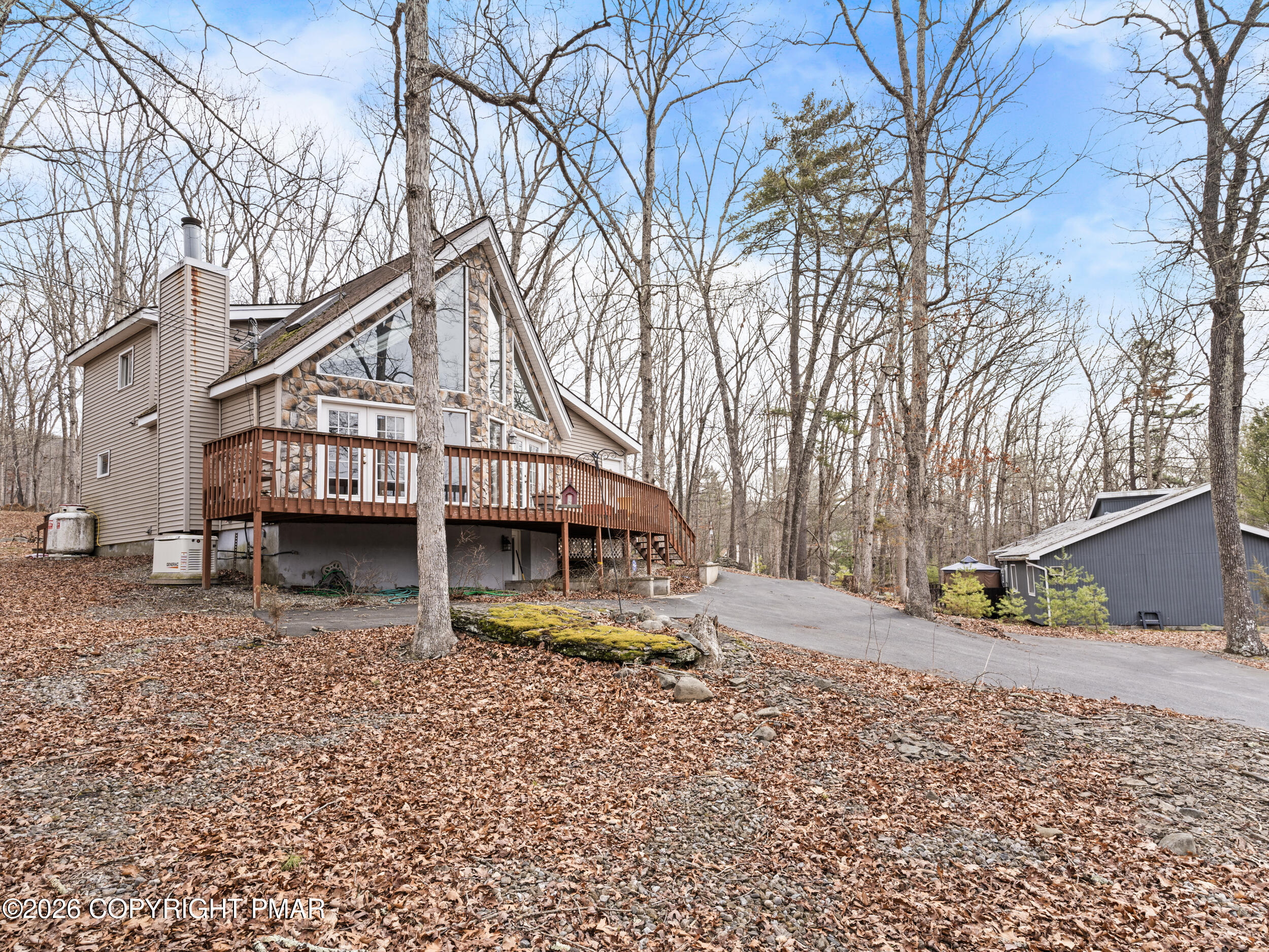 270 Manchester Drive Bushkill, PA 18324 - Photo 3 of 58 a view of house with outdoor space and covered with trees