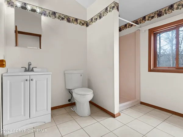 an empty room with a cabinet and mirrors