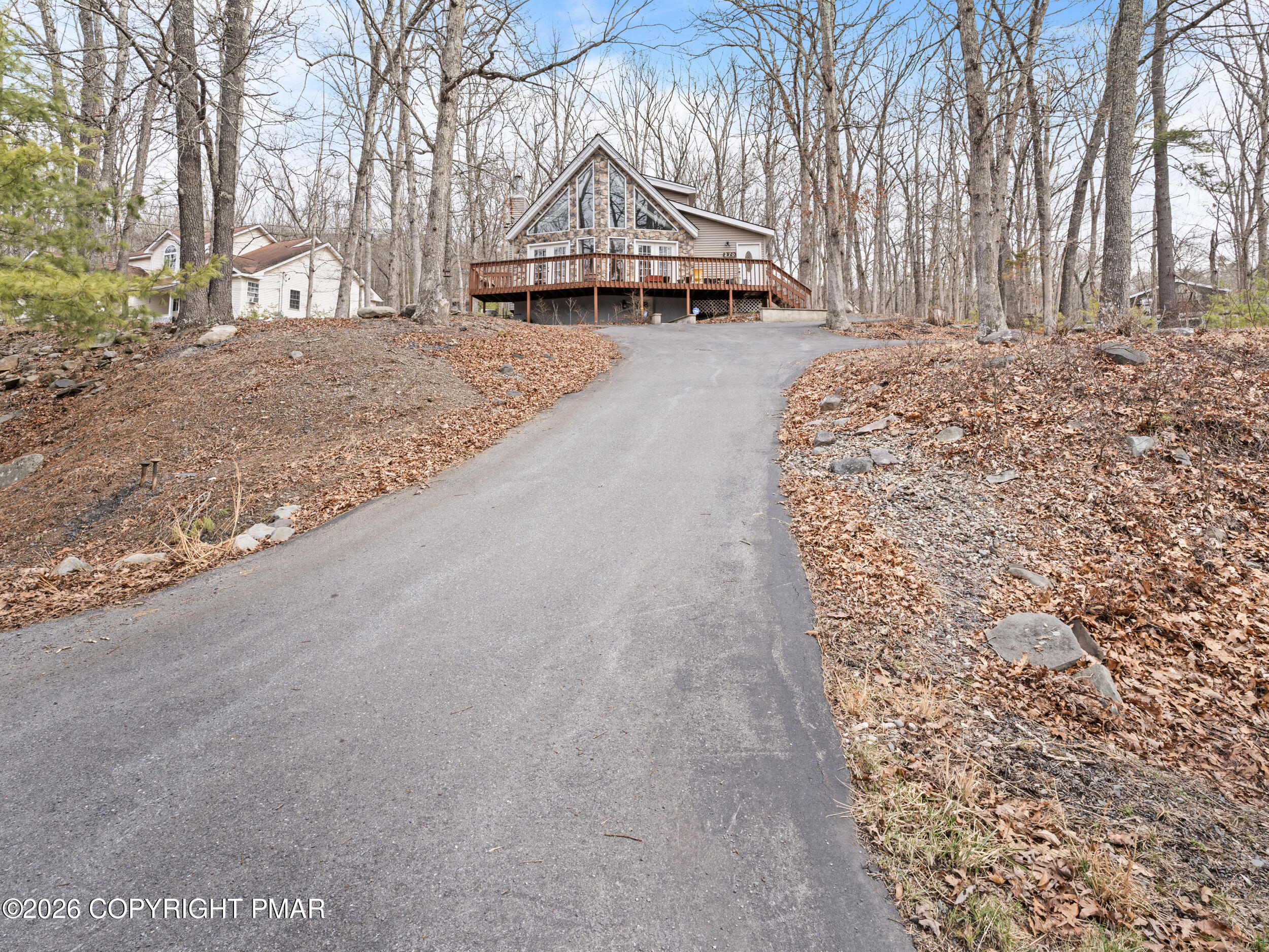 270 Manchester Drive Bushkill, PA 18324 - Photo 5 of 58 a front view of a house with a yard and trees