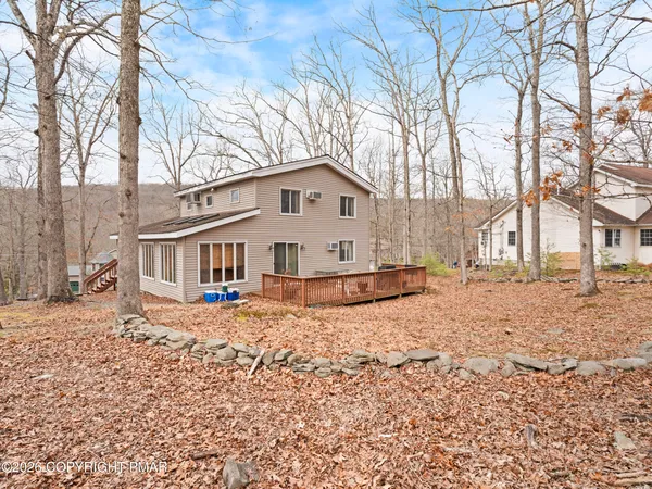 a view of a house with a yard covered in snow