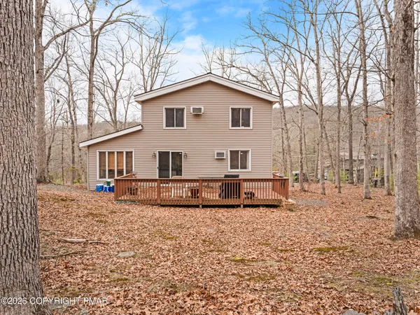 a view of a house with a yard covered in snow