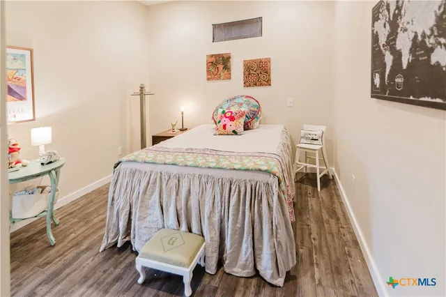 a bedroom with a bed and a dresser in it