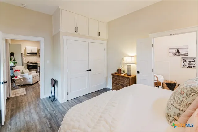 a bedroom with a bed and a large mirror