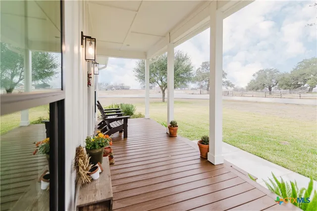 a view of a balcony with wooden floor