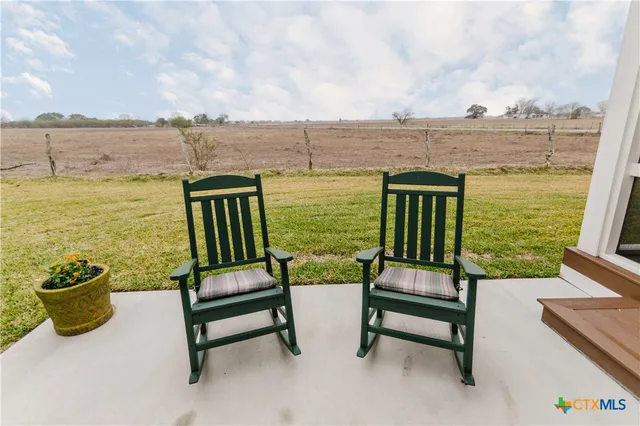 a view of a lake with outdoor seating