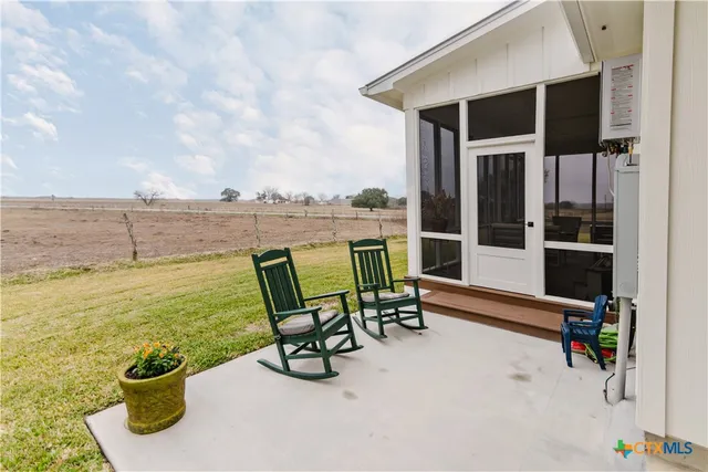 a view of a chair and tables in the terrace