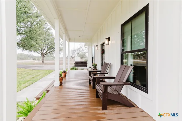 a view of a two chairs in the balcony