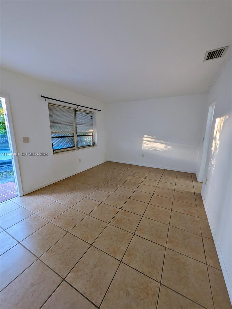 431 Northeast 64th Street, Unit 2 Miami, FL 33138 - Photo 2 of 8 a view of an empty room with a window