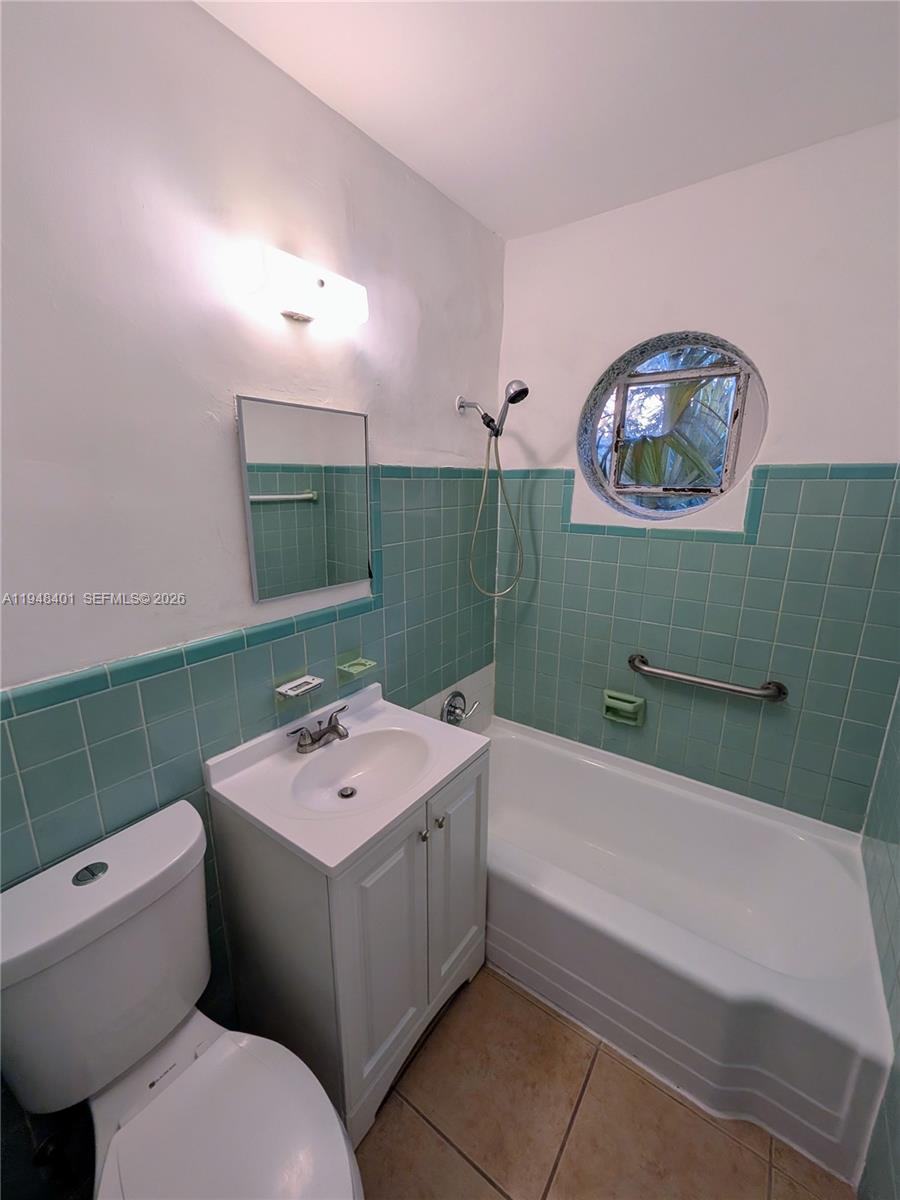 431 Northeast 64th Street, Unit 2 Miami, FL 33138 - Photo 8 of 8 a bathroom with a sink mirror and toilet