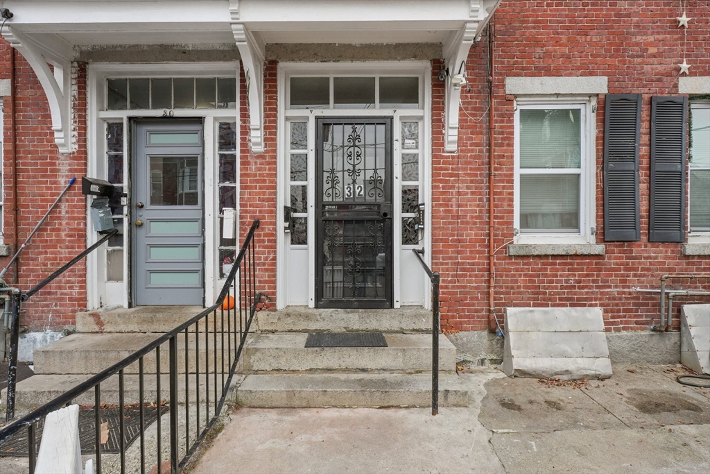 front view of a brick house with large windows