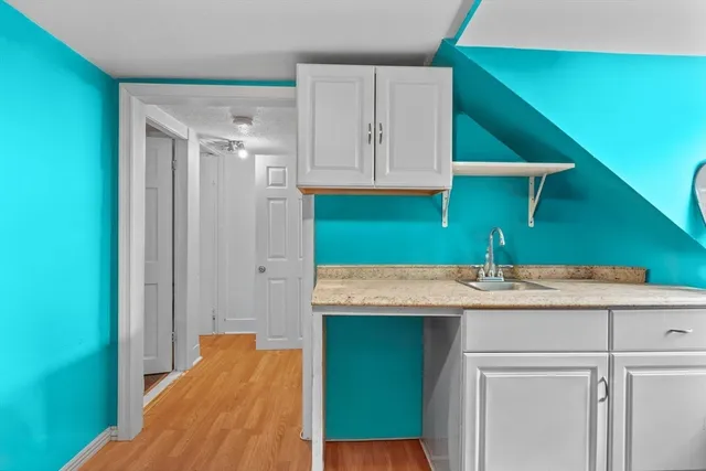 a bathroom with a sink toilet and a mirror