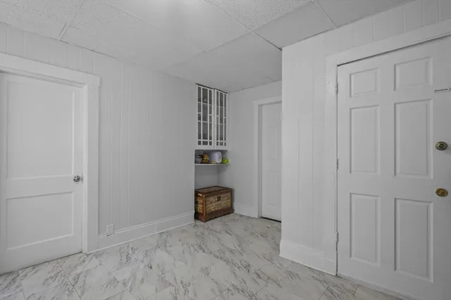 a kitchen with a refrigerator and white cabinets