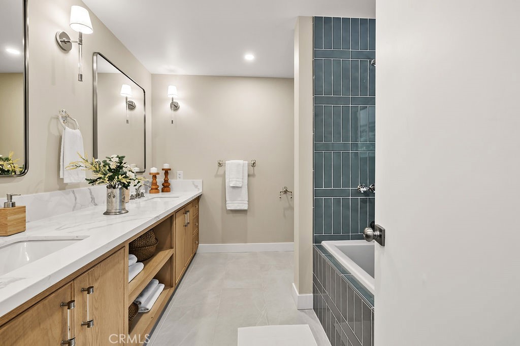 275 Fairview Road Ojai, CA 93023 - Photo 37 of 74 a spacious bathroom with a double vanity sink a large mirror and a shower