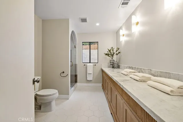 a view of a house with a yard and large trees