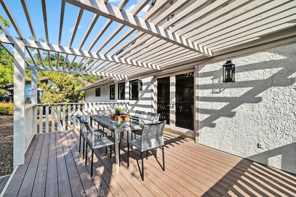 275 Fairview Road Ojai, CA 93023 - Photo 62 of 74 a view of a patio with table and chairs with wooden floor and fence