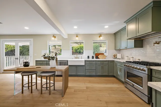 a kitchen with granite countertop a refrigerator and a sink
