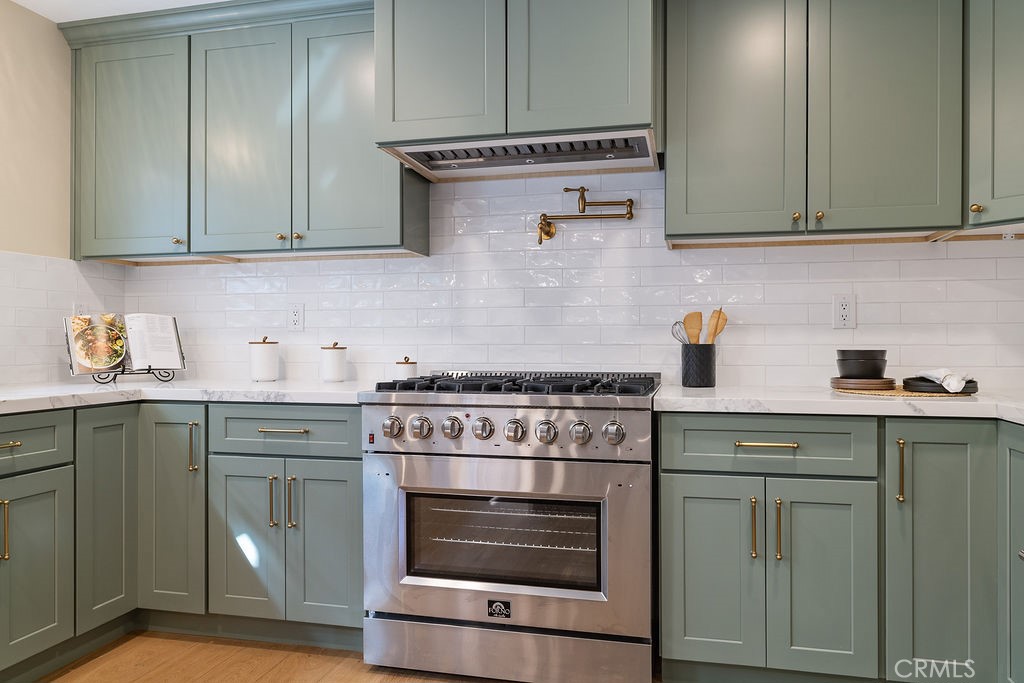275 Fairview Road Ojai, CA 93023 - Photo 9 of 74 a kitchen with granite countertop white cabinets and white appliances