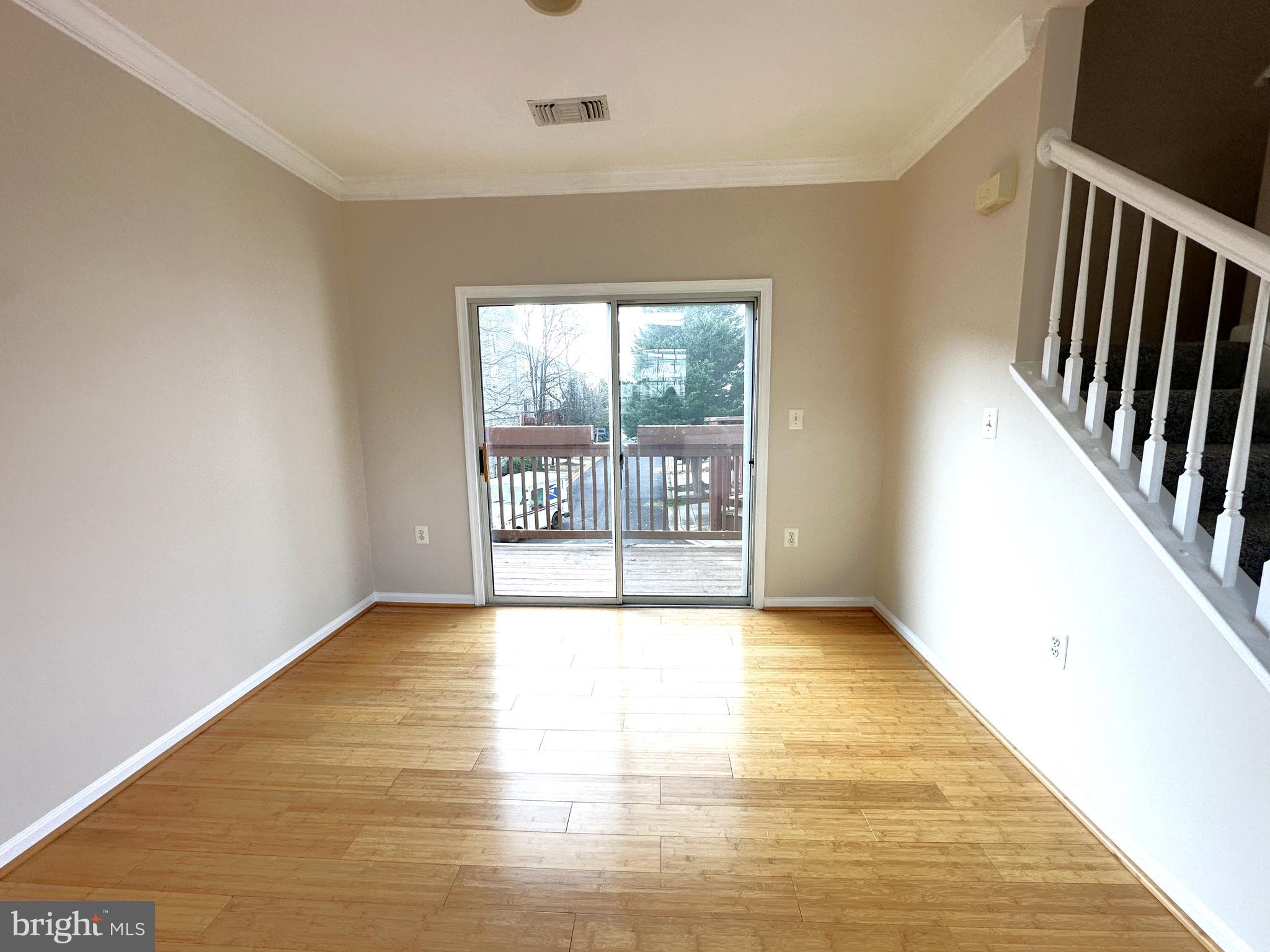 21798 Jarvis Square Ashburn, VA 20147 - Photo 6 of 29 a view of an empty room with wooden floor and a window