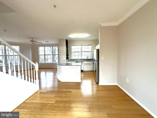 a view of kitchen and hall with wooden floor
