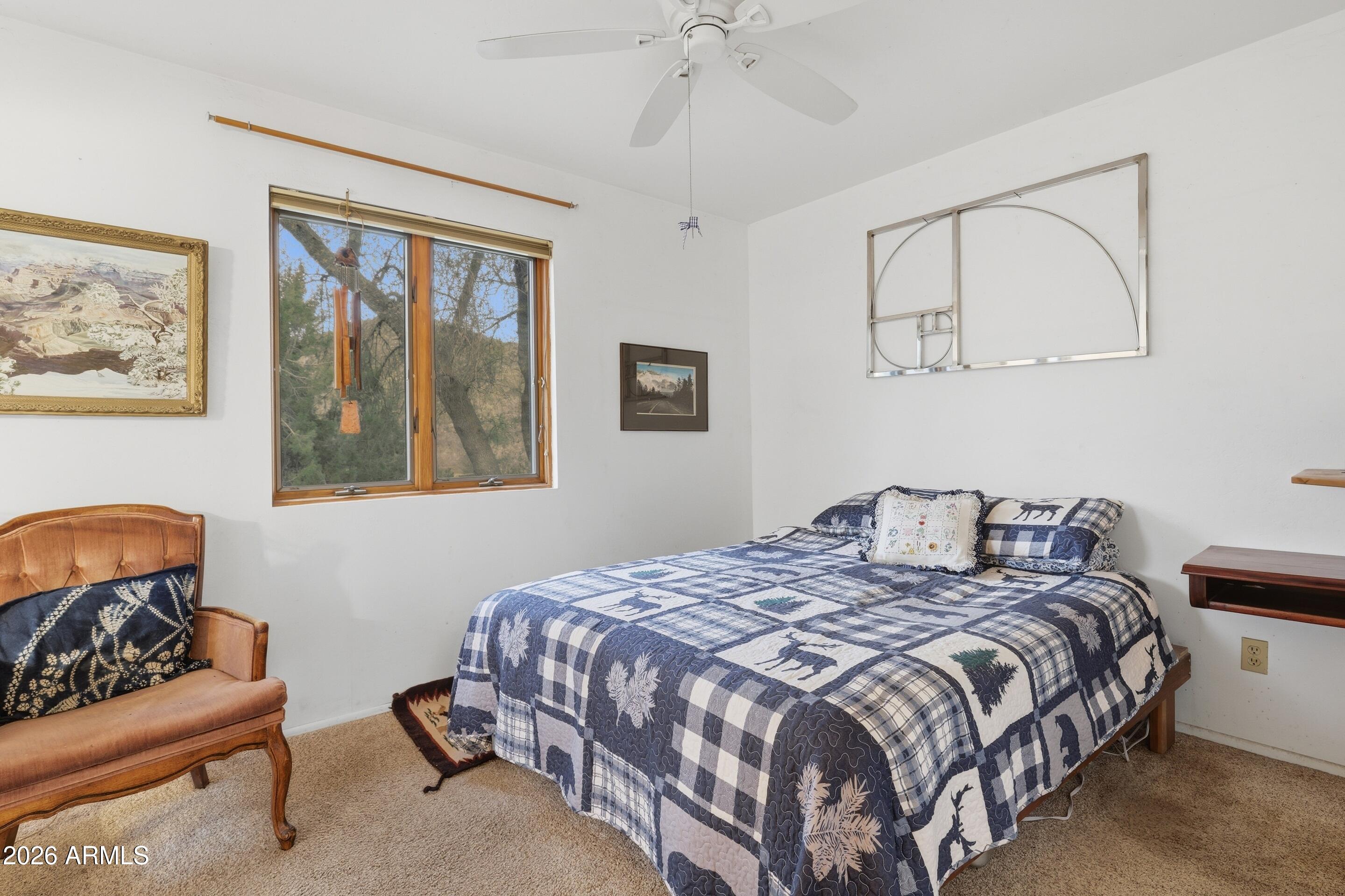 8135 West Gibson Ranch Road Payson, AZ 85541 - Photo 10 of 43 a bedroom with a bed and a couch