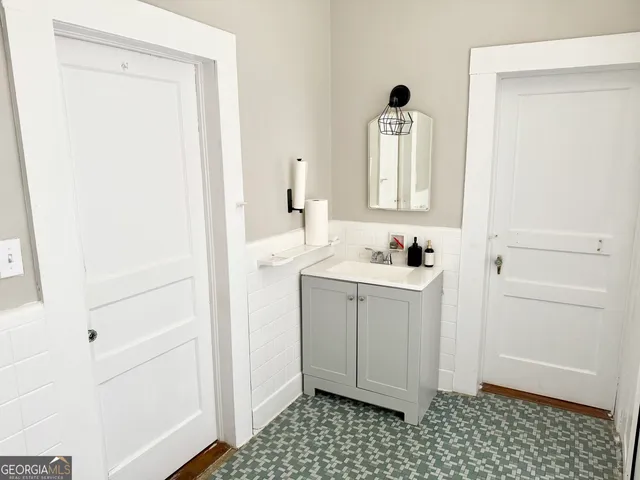a white toilet sitting next to a bathroom sink and vanity