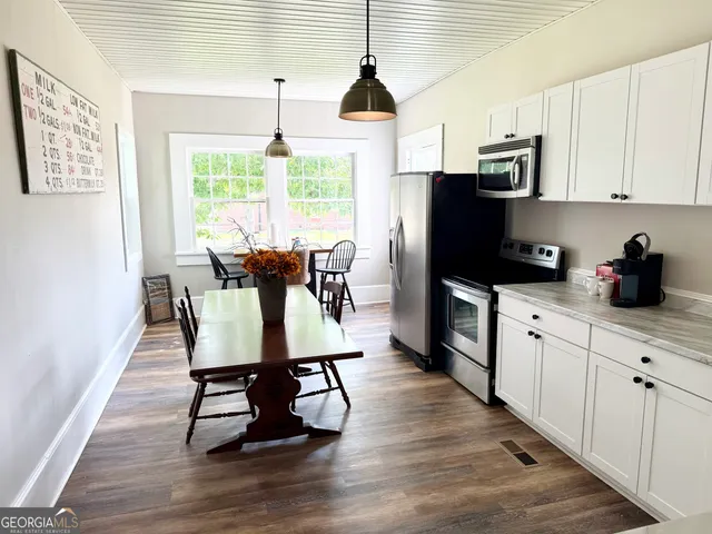 a view of a dining room with furniture window and wooden floor