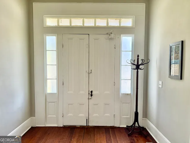 a view of a hallway with wooden floor