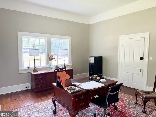a view of a workspace with furniture and a window