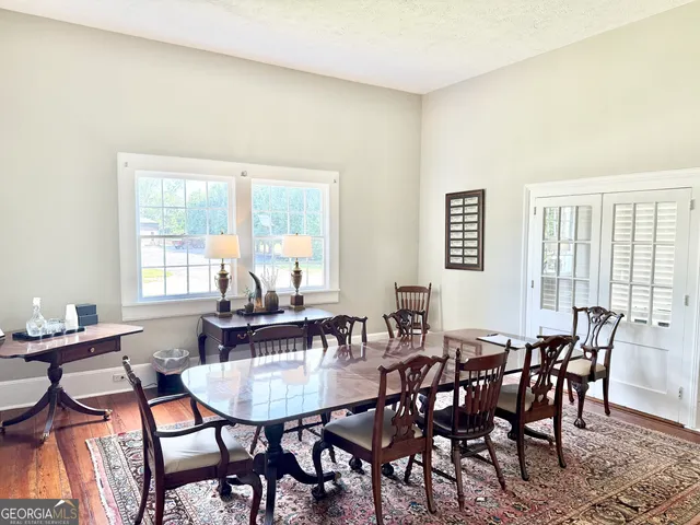 a view of a dining room with furniture and window