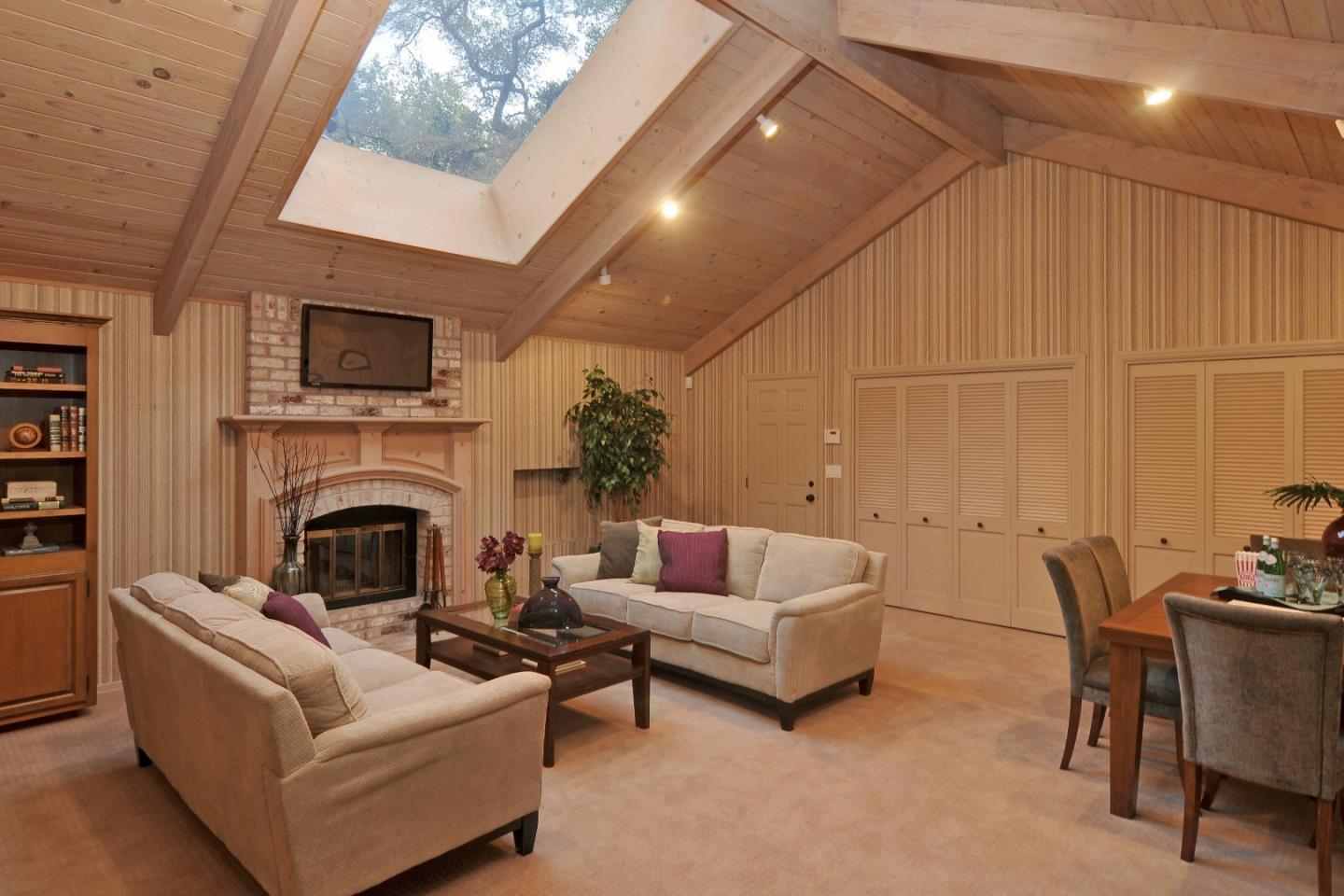 3470 Tripp Road Woodside, CA 94062 - Photo 12 of 34 a living room with furniture a fireplace and a flat screen tv