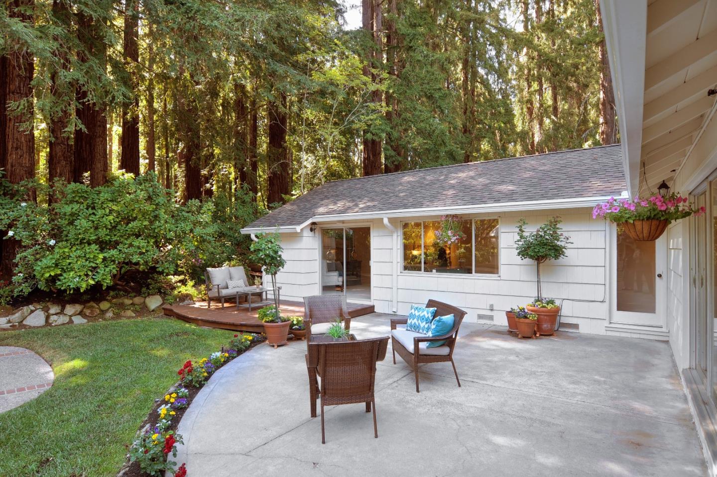 3470 Tripp Road Woodside, CA 94062 - Photo 23 of 34 a view of a patio with table and chairs potted plants and a large tree