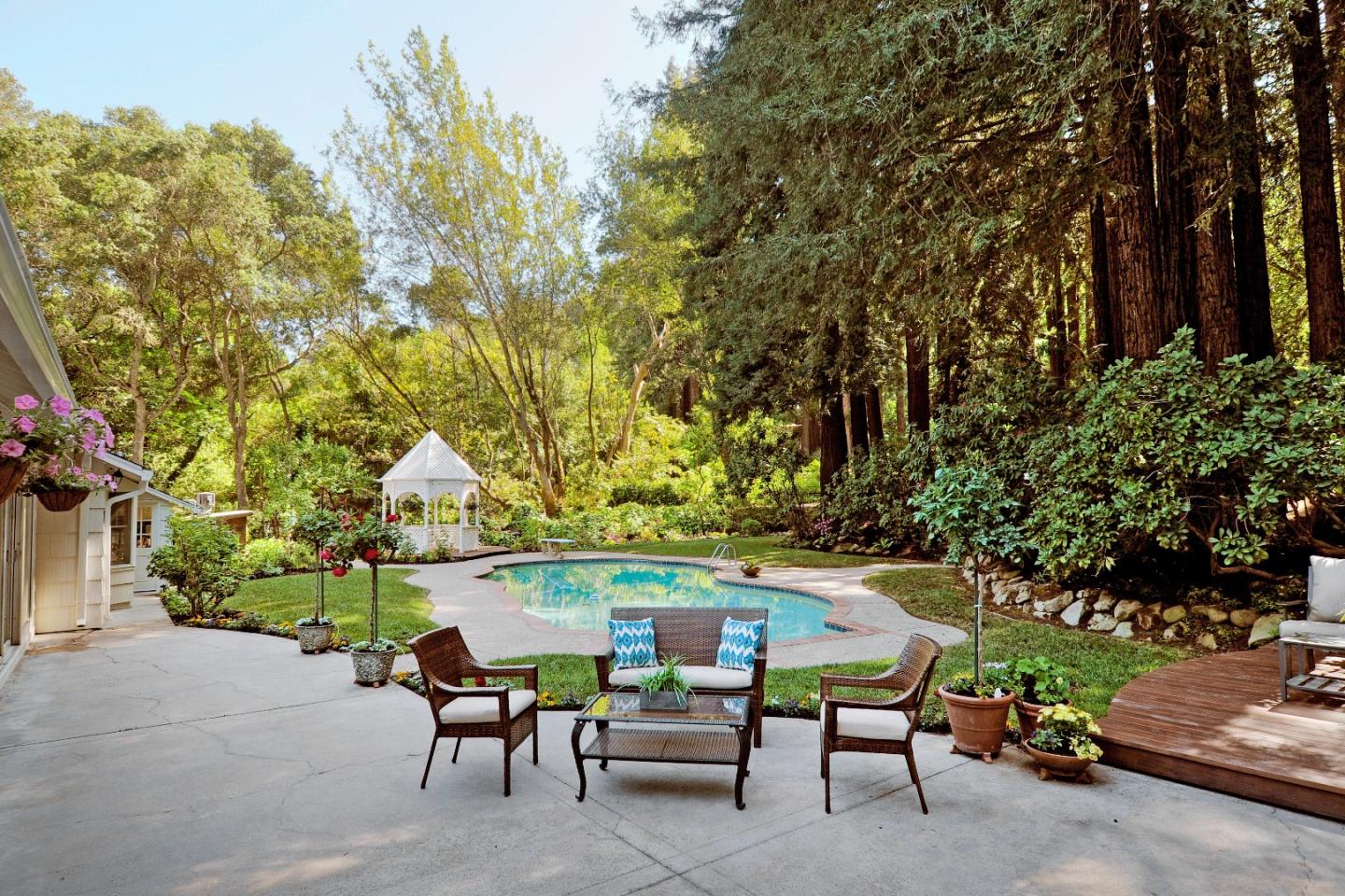 3470 Tripp Road Woodside, CA 94062 - Photo 24 of 34 a view of a patio with table and chairs under an umbrella